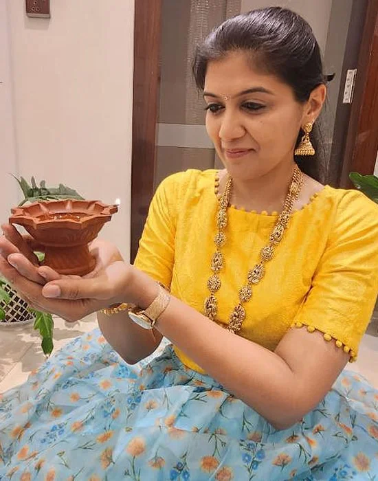 Dr. Sneha Maroo holding a diya